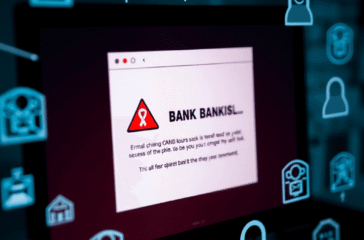 Close-up of a computer screen showing a suspicious email with a fake bank logo and cybersecurity warning icons.